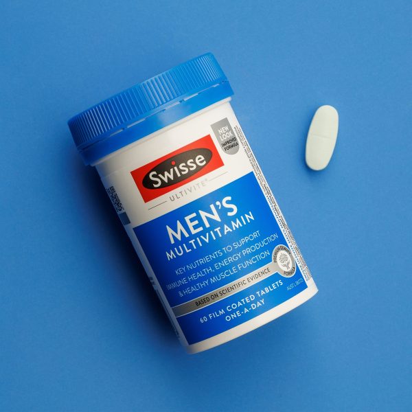 Swisse Men’s Multivitamin bottle with blue lid on a blue background and a single white tablet nearby (60 tablets).
